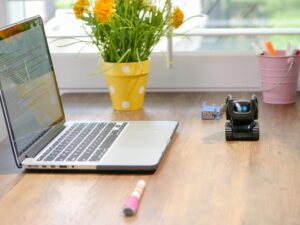 Laptop and a toy robot on a desk